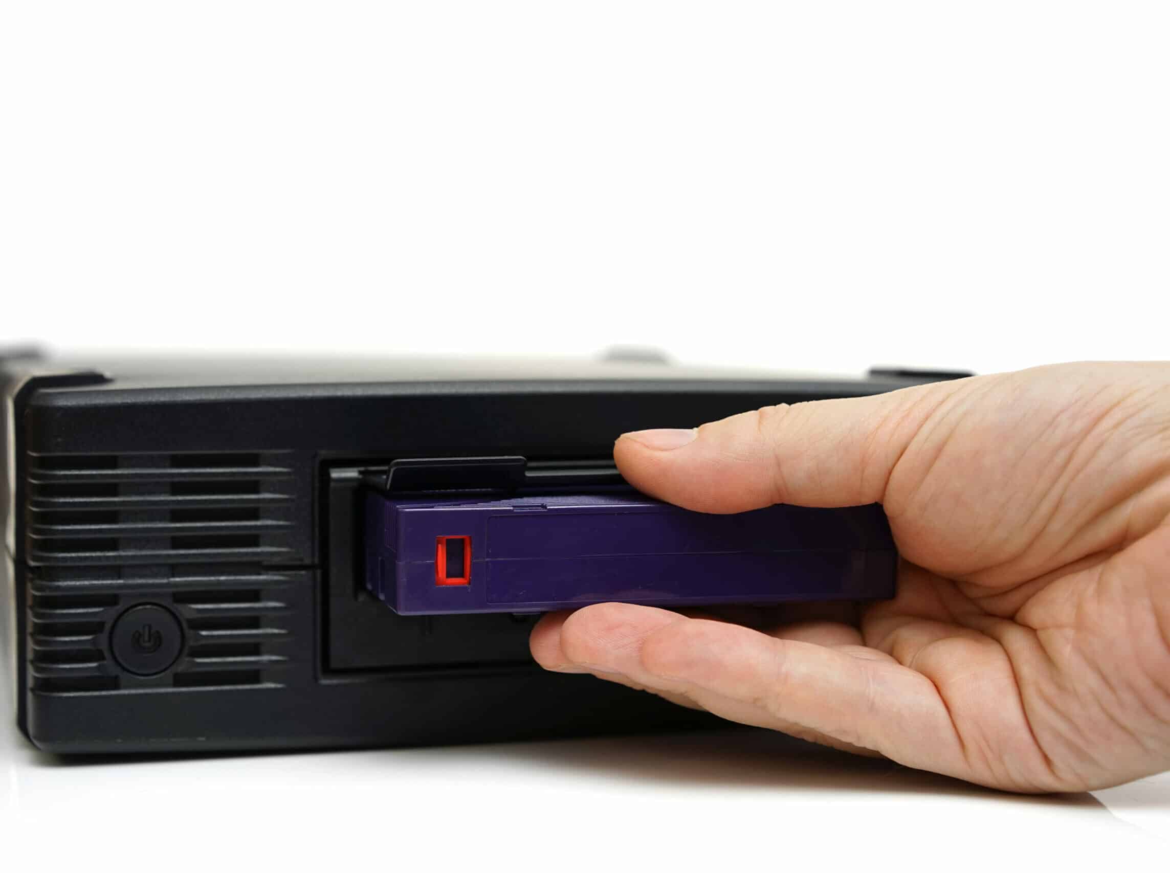 system administrator inserting a backup tape in a backup unit